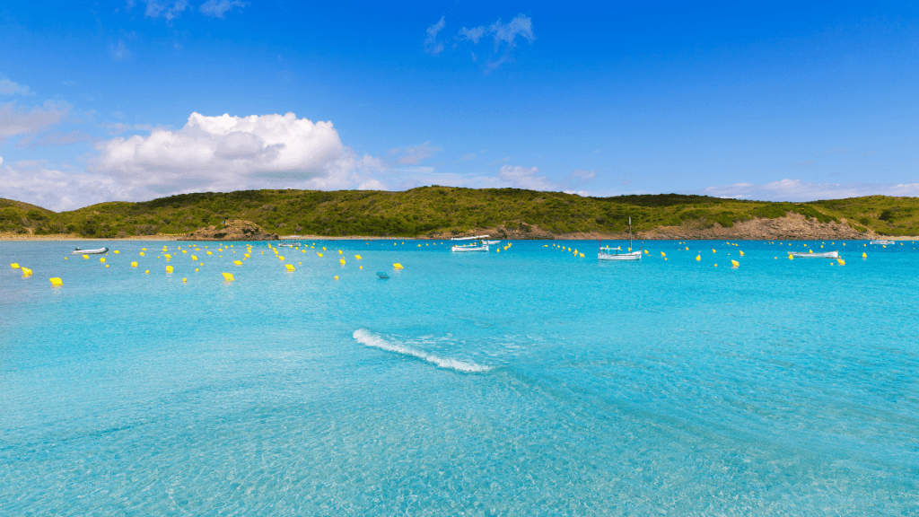 Clear blue waters of Es Grau Beach Menorca