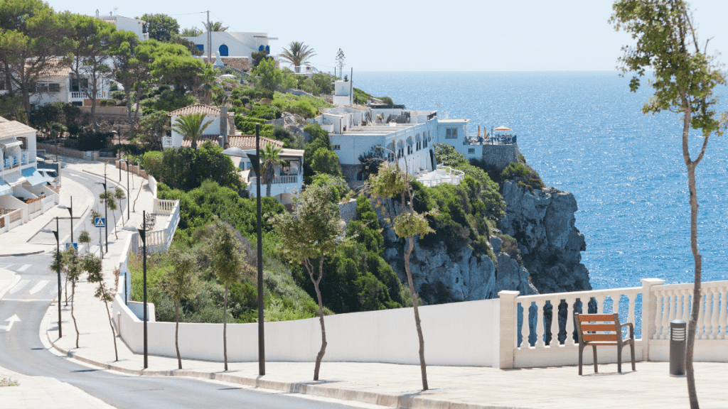 View of a street and the sea in Cala en Porter Menorca