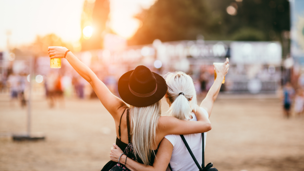 Two ladies with beers in their hands celebrating