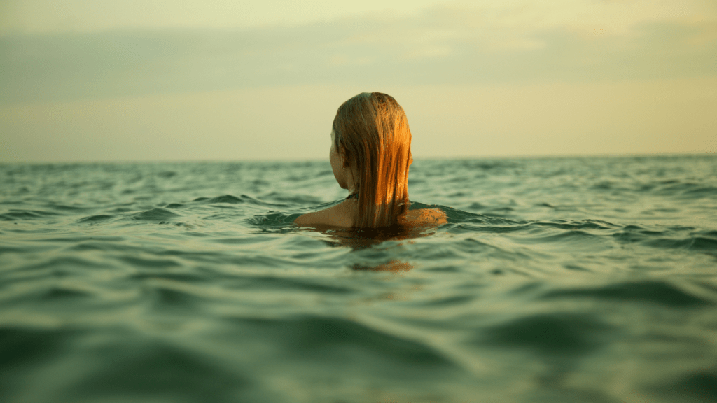 A girl swimming in an ocean