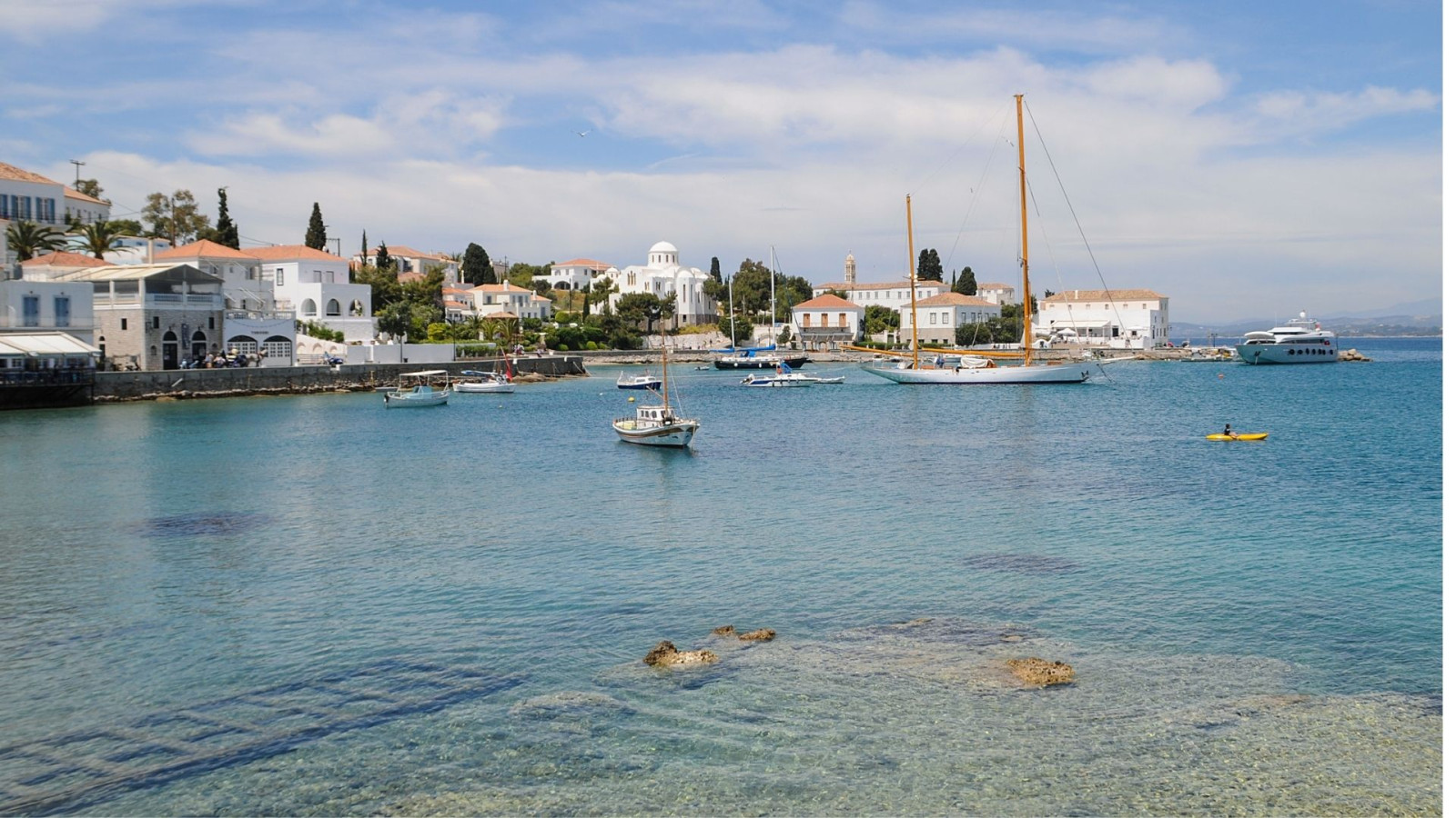Boats docked on crystal clear water.
